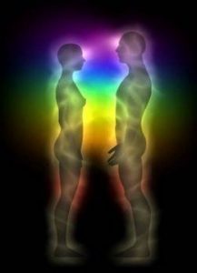 An image of the silhouettes of two people, surrounded by rainbow colors so as to symbol pranic energy.