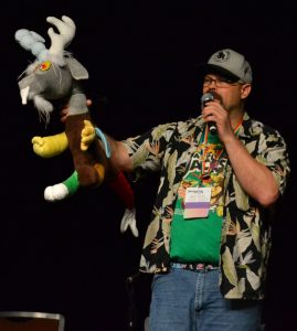 Image of Dustykatt speaking at Bronycon while holding a My Little Pony plush toy