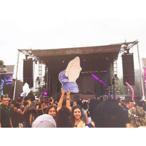 Praying Hands Totem for Tchami @ EverAfter Music Festival 2015. Two women in the crowd are holding the sign up in front of the stage.