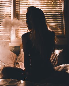 a silhouette of a woman smoking