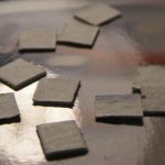 Several small sqquares of paper scattered on a surface