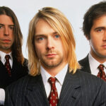 Photoshoot of Nirvana members in suits and ties, from left to right: Krist Novoselic, Kurt Cobain, Steve Grohl