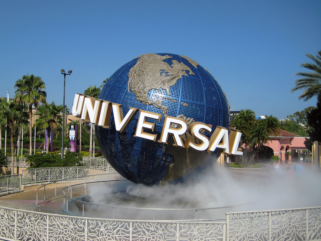 Universal Studios Logo Sculpture in Universal Studios Park in Orlando, Fl. A large steel-frame colored Earth on a tilted axis with "UNIVERSAL" sprawled across, with a water fountain underneath
