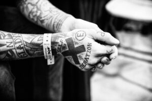An individual with an X on their hand to denote their membership in straight edge.