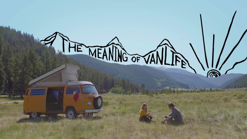 Two people sit next to a van in front of a mountainous landscape. "The meaning of vanlife" is written above the mountains.