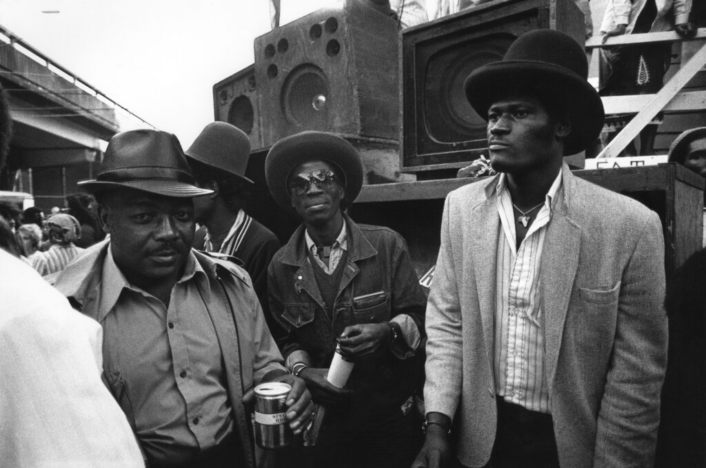 3 men in front of a sound system.