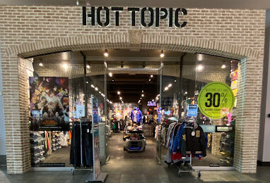 Hot Topic storefront displaying the logo on white brick.