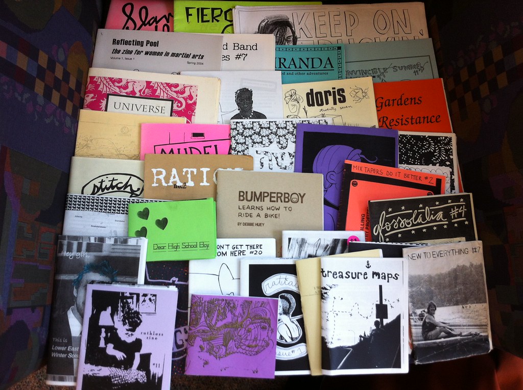 A selection of printed zines in different colors and papers.